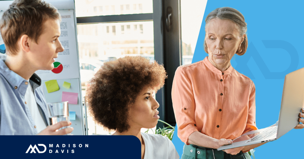 Three employees of diverse gender, race, and age in discussion