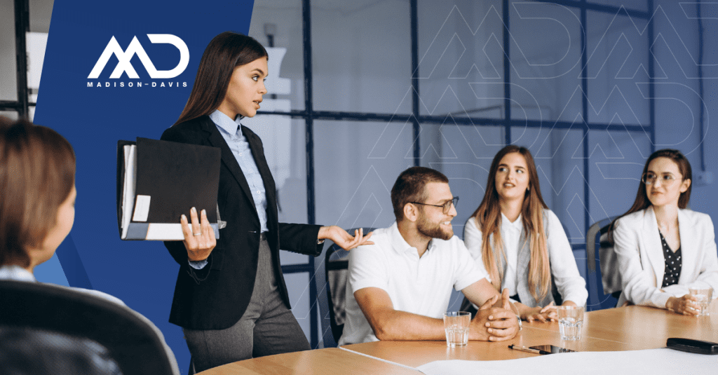 Group of people in business attire discussing at a conference table