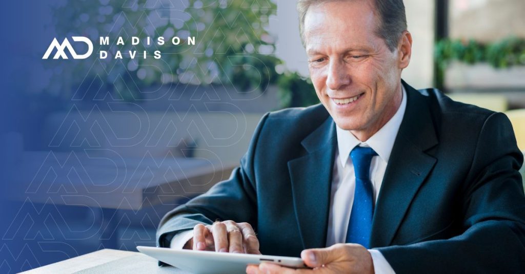 Professional in suit and tie works on a tablet