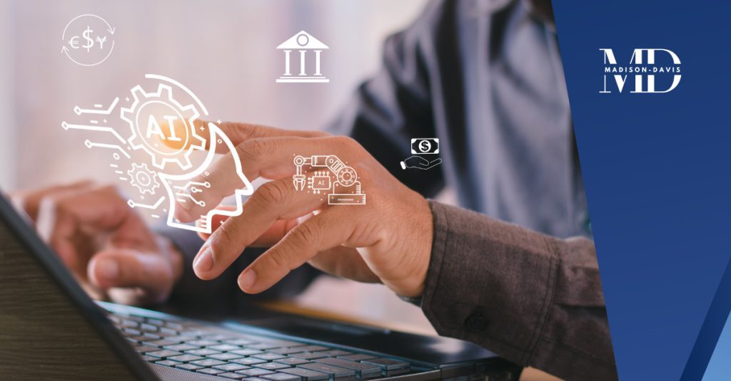 A man in business attire typing on a laptop touches 2D floating icons saying "AI"