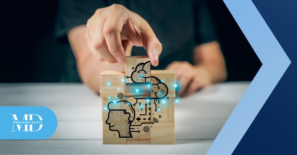 Executive completes a wooden block puzzle that depicts a person's mind