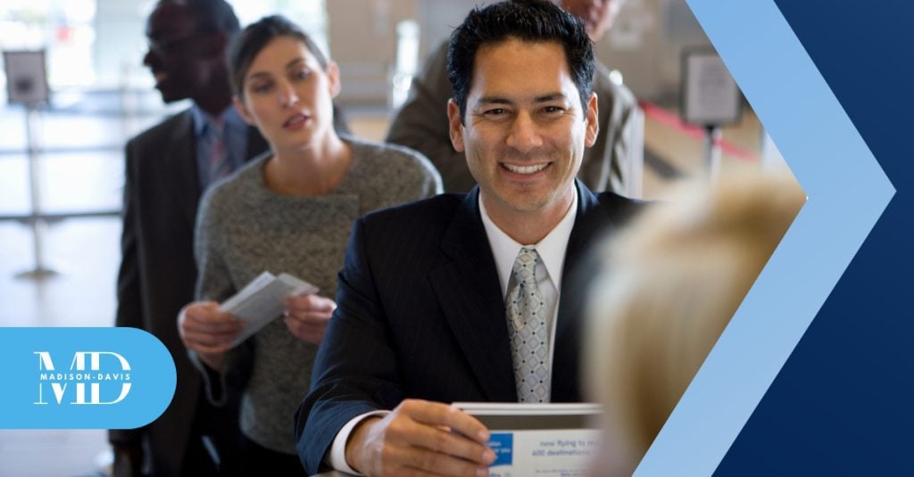 Smiling finance professional speaks to client at office